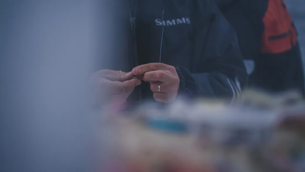 Jaime tying a knot for a fly aboard Boylermaker