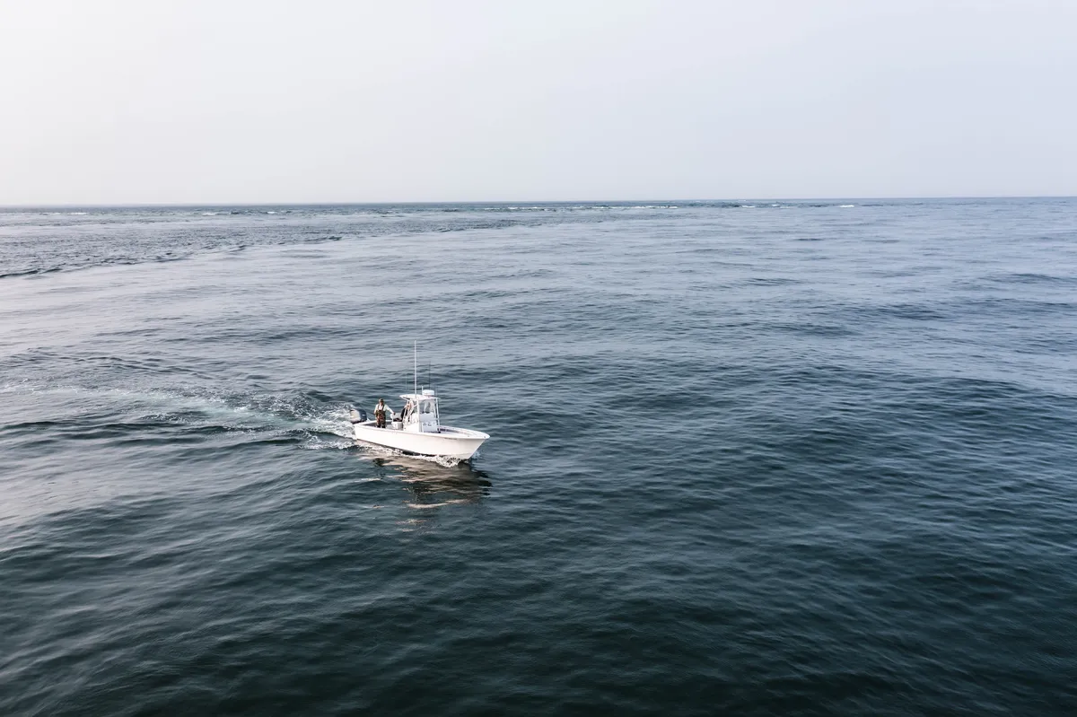 A center console fishing boat running across open water off Martha's Vineyard
