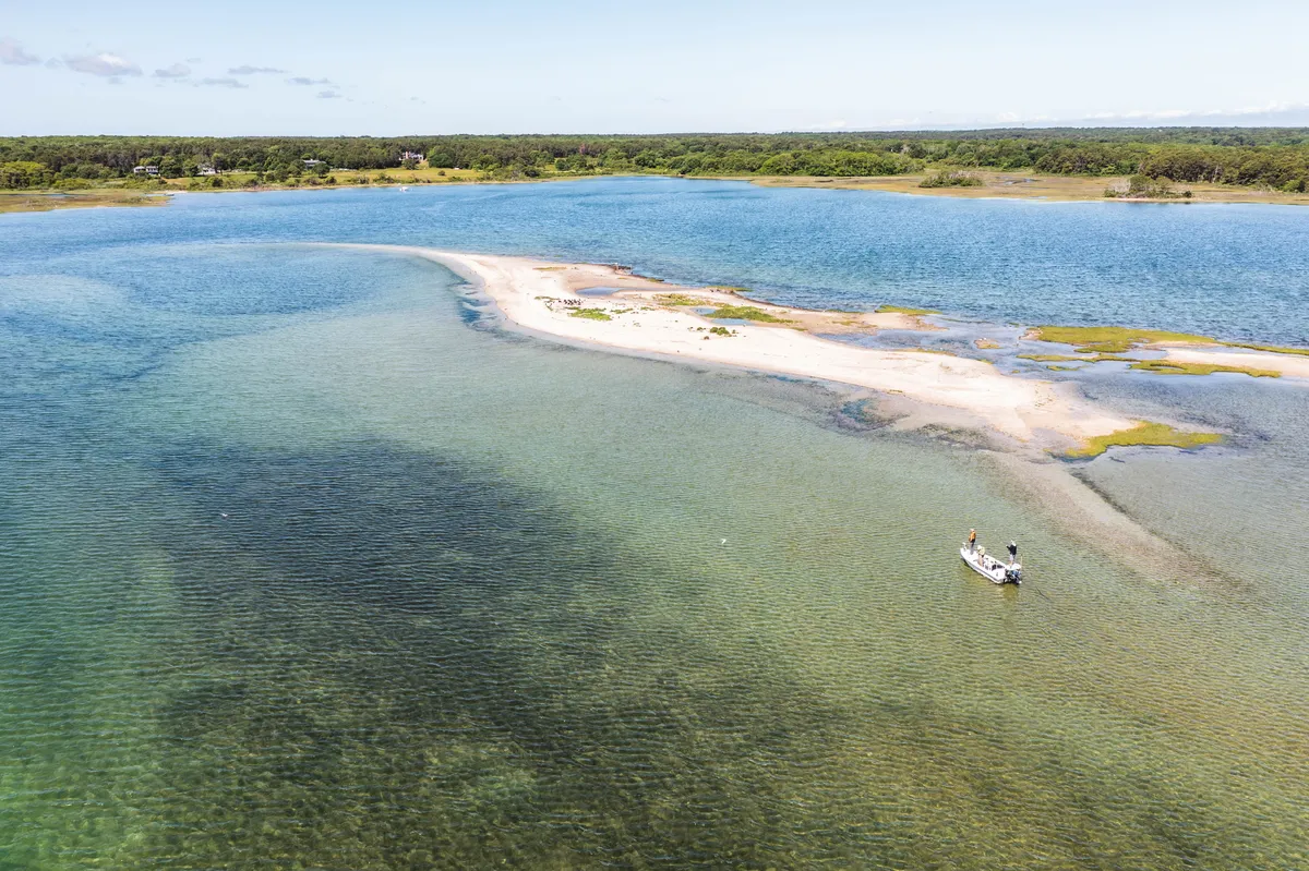 Aerial view of a flats skiff beside a sandbar in a shallow Martha's Vineyard salt pond